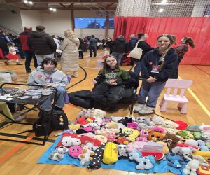 wolontariusze przy stoisku z maskotkami..