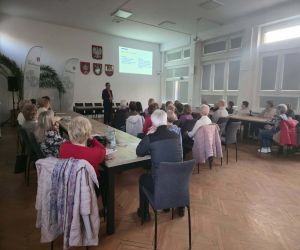 słuchacze z Uniwersytetu Trzeciego Wieku wraz z prowadzącym